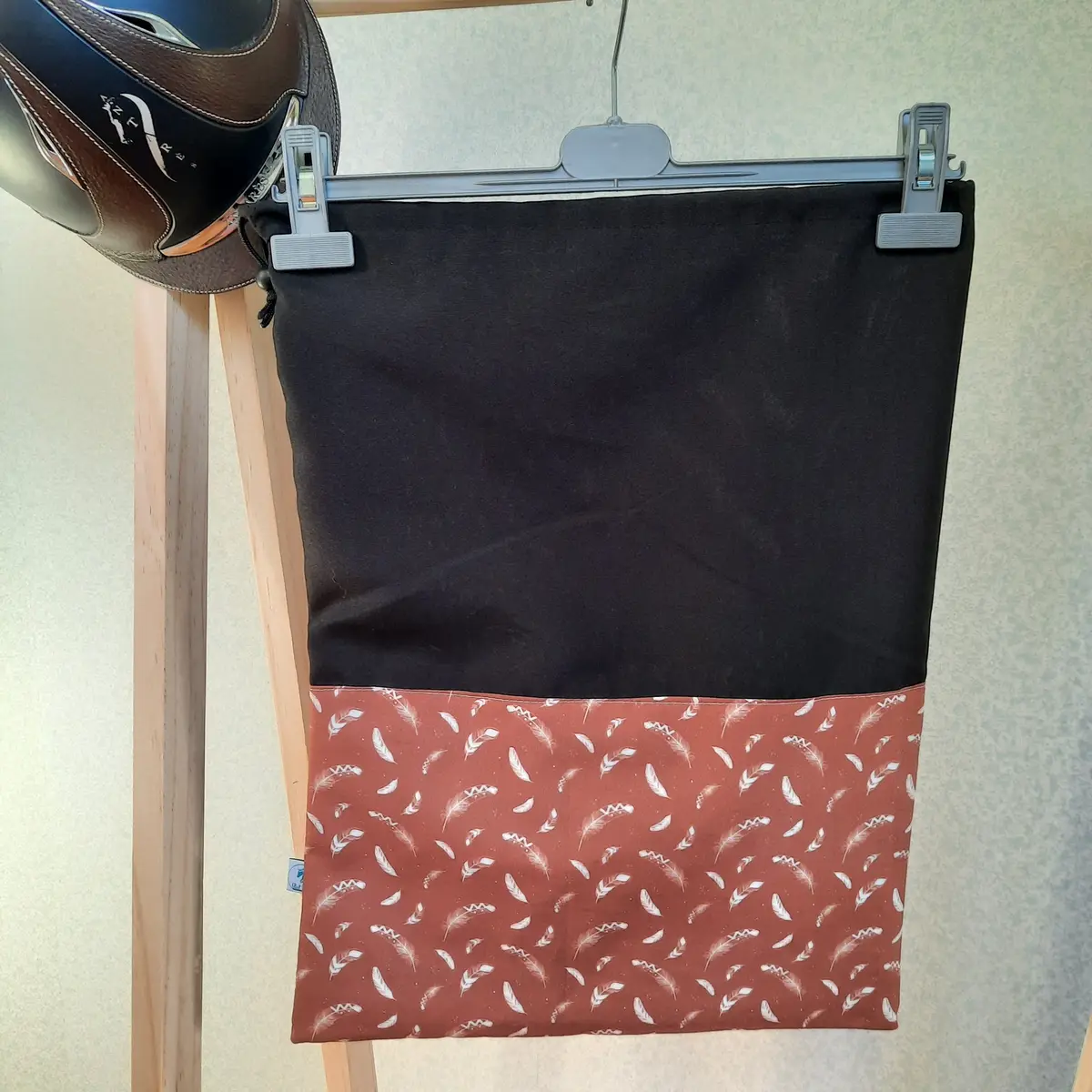 Two-tone black and feathers helmet bag