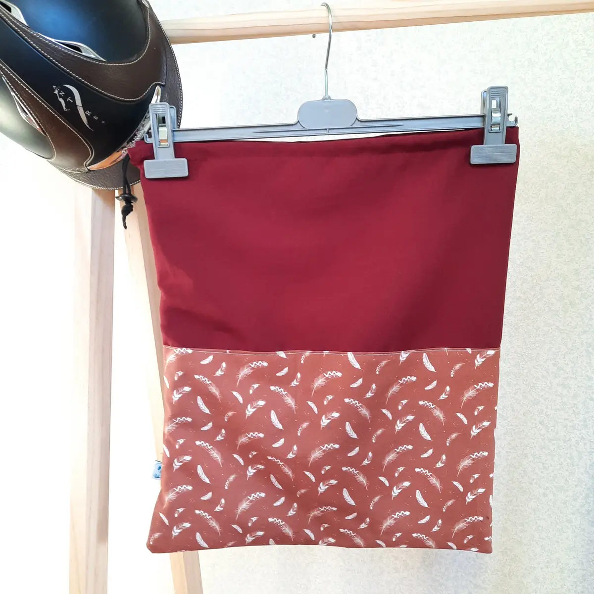 Two-tone burgundy and feathers helmet bag